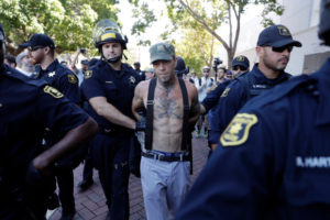 A demonstrator is arrested during a free speech rally Sunday, Aug. 27, 2017, in Berkeley, Calif. Several thousand people converged in Berkeley Sunday for a "Rally Against Hate" in response to a planned right-wing protest that raised concerns of violence and triggered a massive police presence. Several people were arrested for violating rules against covering their faces or carrying items banned by authorities. (AP Photo/Marcio Jose Sanchez)