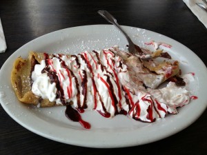Tammie's homemade strawberry nutella crepe, topped with whipped cream and syrup.
