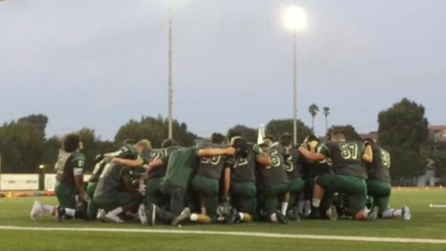 Mira Costa Varsity Football Team praying before playing Redondo Union.